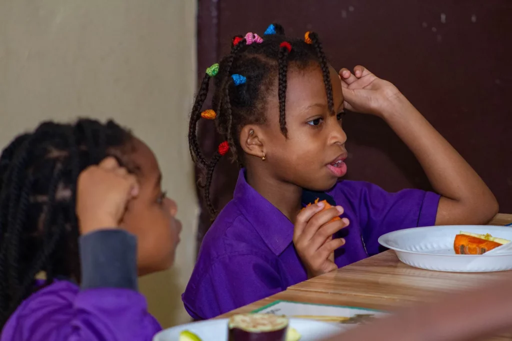 school girl eating in bilingual school in amitie dakar senegal