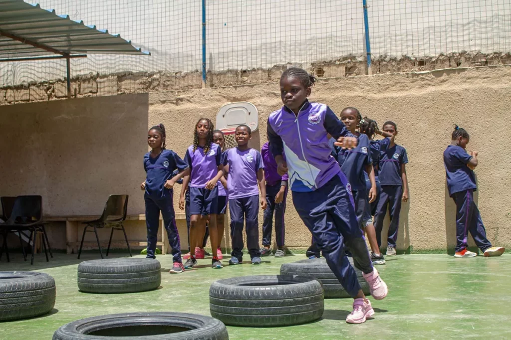 girl doing physical educstion in bilingual school in amitie dakar senegal