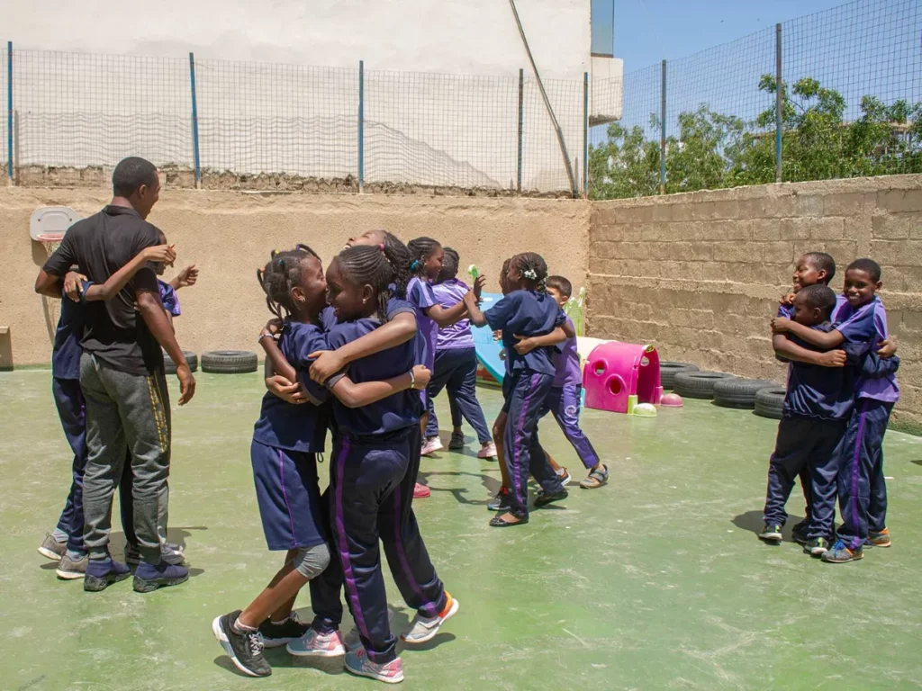 students hugging in bilingual school in amitie dakar senegal